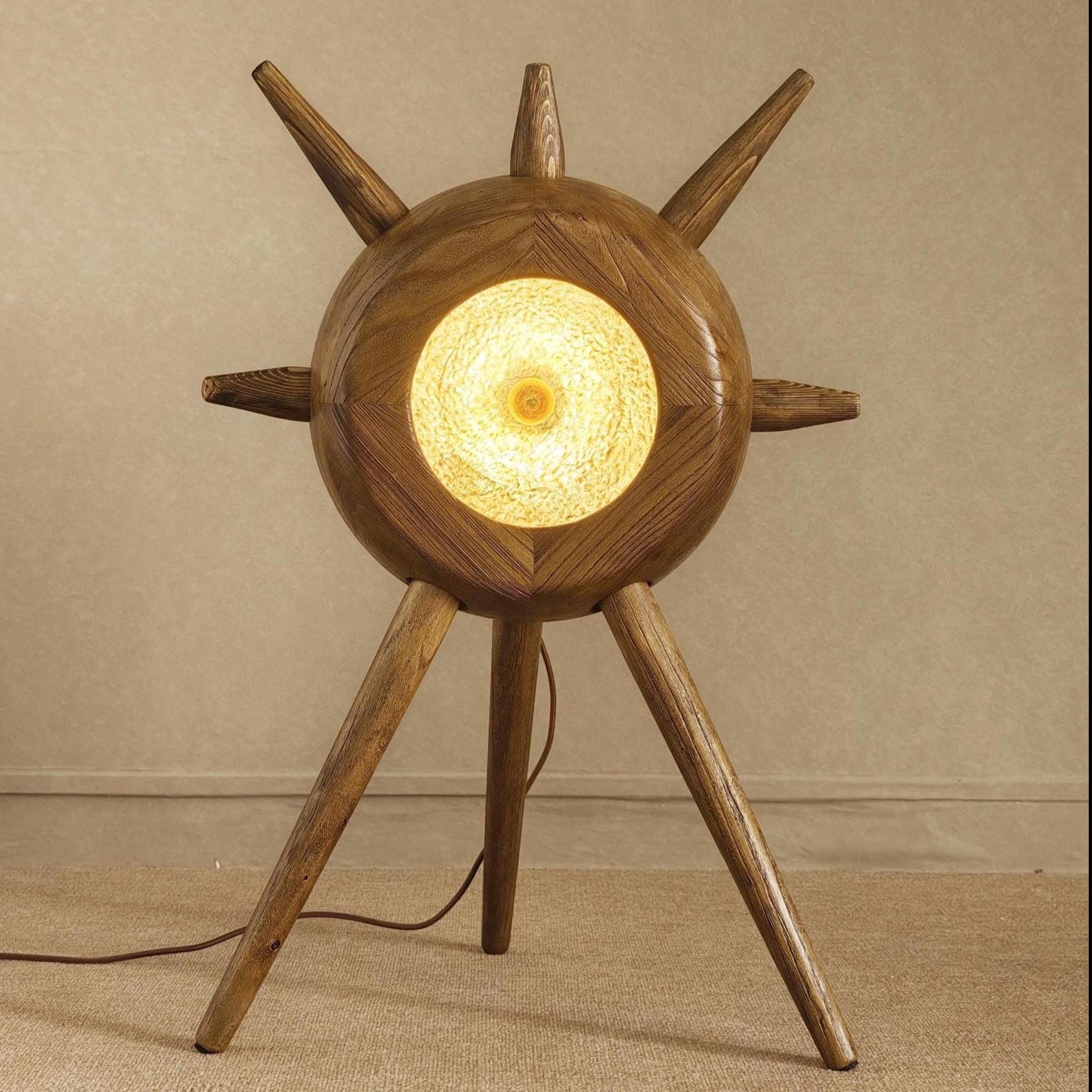 Wooden table lamp with a warm glow on a beige background