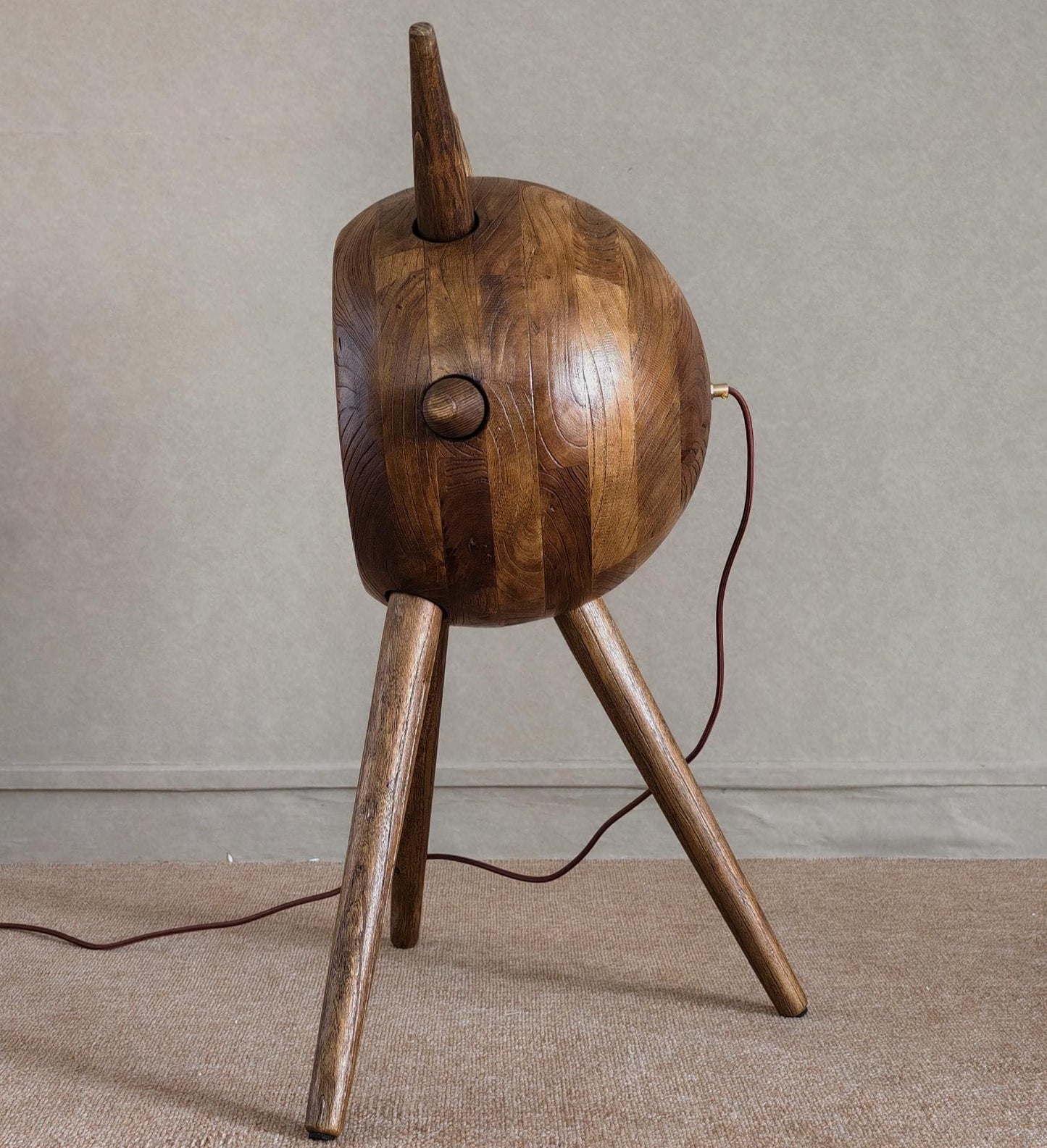 Wooden lamp with a unique design on a neutral background