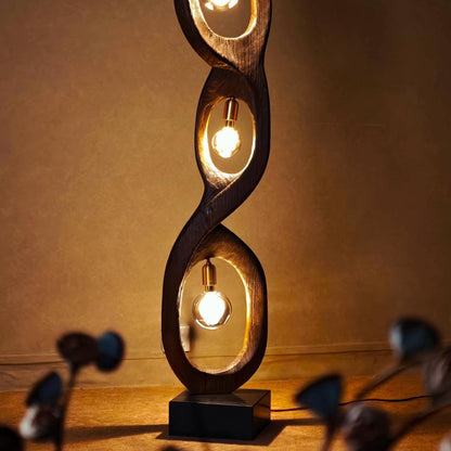 Decorative floor lamp with spiral design on a wooden floor.