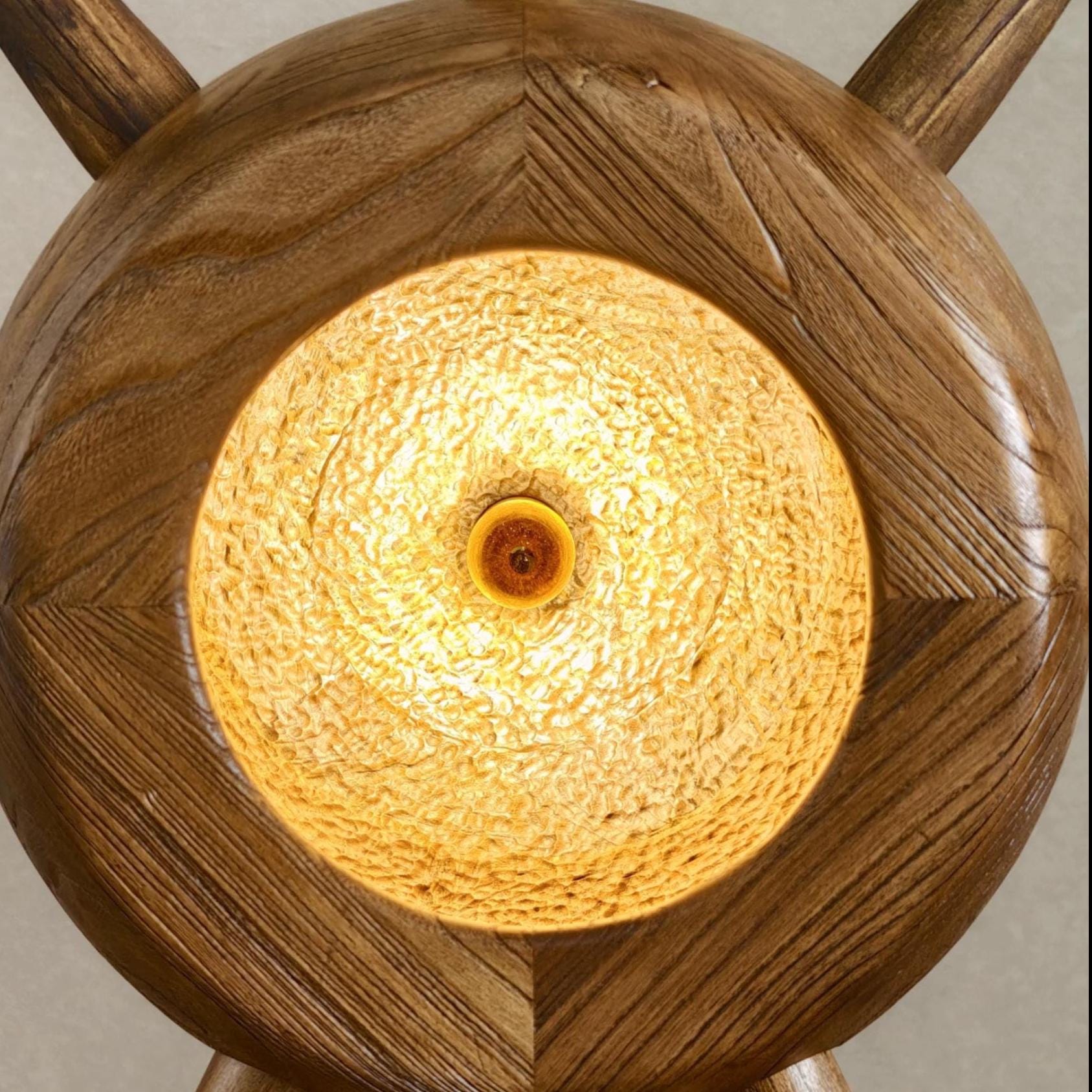 Wooden lamp with a textured glass shade on a neutral background