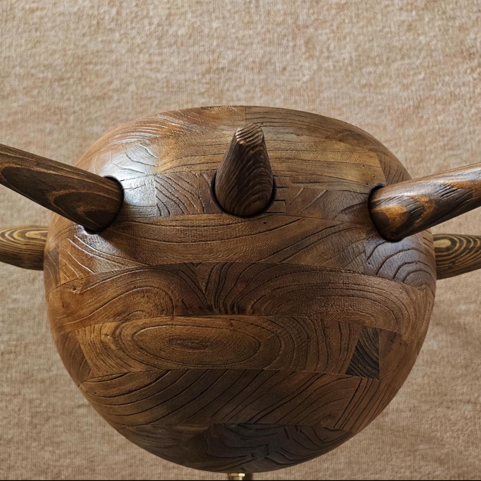 Wooden ball with handles on a beige background