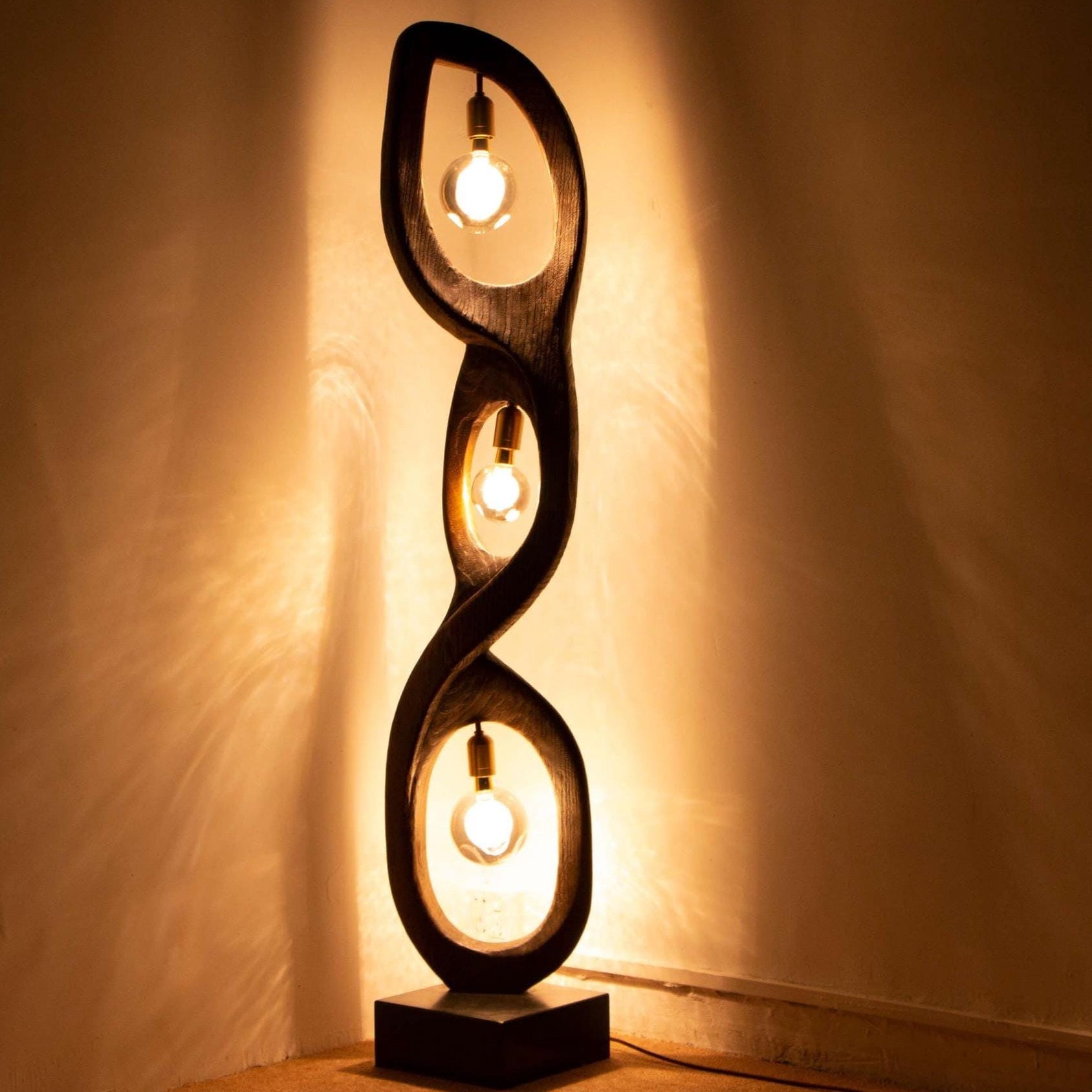 Decorative floor lamp with spiral design on a plain background