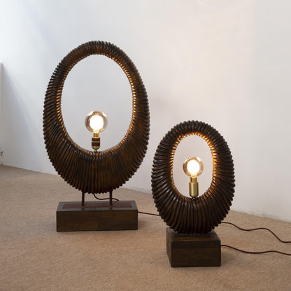 Two unique table lamps with circular designs on a plain background